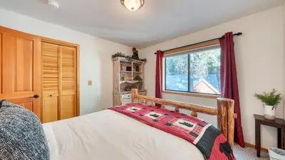 a bedroom with a bed and a window at Cozy Escape w Hot Tub Deck Access to Tahoe Donner Skiing Alpenglow Chalet by AvantStay in Truckee
