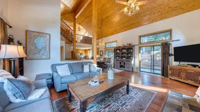 a living room with a couch and a table at Cozy Escape w Hot Tub Deck Access to Tahoe Donner Skiing Alpenglow Chalet by AvantStay in Truckee
