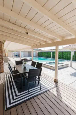 a patio with a table and chairs under a pavilion at Villa Luxury Family Getaway in Patterson