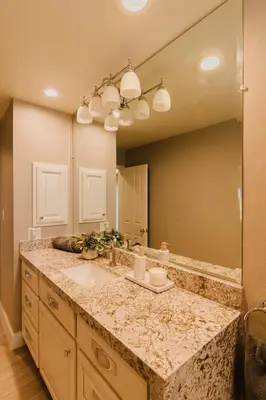 a bathroom with a sink and a large mirror at Villa Luxury Family Getaway in Patterson
