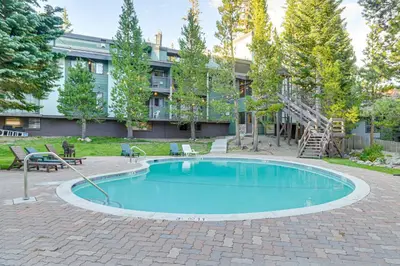 a swimming pool in front of a building at St Anton Condo in Mammoth Lakes! in Mammoth Lakes