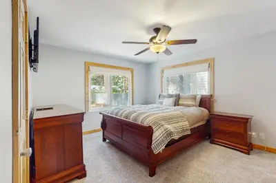 a bedroom with a bed and a ceiling fan at Tata Cabin in South Lake Tahoe