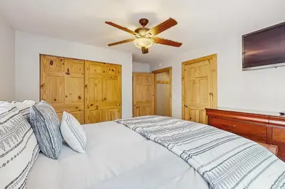 a bedroom with a bed with a ceiling fan at Tata Cabin in South Lake Tahoe