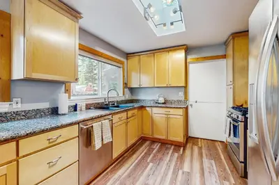 a kitchen with wooden cabinets and a white refrigerator at Tata Cabin in South Lake Tahoe