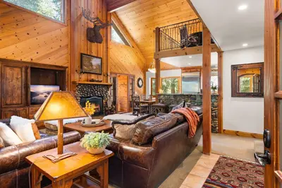 a living room with a leather couch and a fireplace at Luxury 4BR Retreat Near Northstar Sleeps 10 in Tahoe Vista