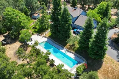 an aerial view of a house with a swimming pool at The Blue Resort of Yosemite - Pool, Spa, Games in Mariposa