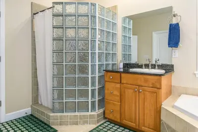 a bathroom with a glass walled shower and a sink at The Blue Resort of Yosemite - Pool, Spa, Games in Mariposa