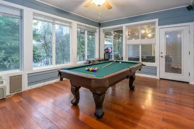 a pool table in a room with windows at The Blue Resort of Yosemite - Pool, Spa, Games in Mariposa