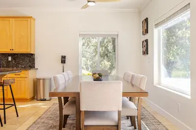 a dining room with a wooden table and chairs at Beautiful Lake Views with Hot Tub and Space for Family in Oakhurst