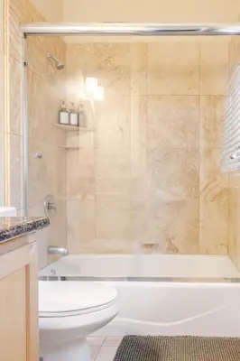 a bathroom with a tub and a toilet and a shower at Beautiful Lake Views with Hot Tub and Space for Family in Oakhurst