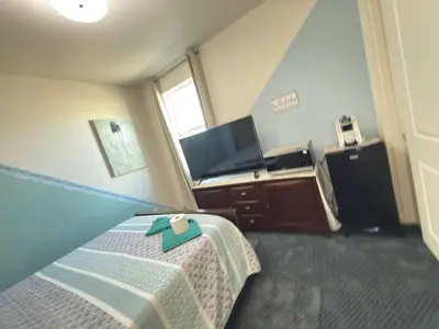 a hotel room with a bed and a sink at Peaceful Private Room in Sparks in Sparks