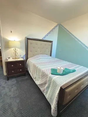 a bedroom with a bed with a blue wall at Peaceful Private Room in Sparks in Sparks