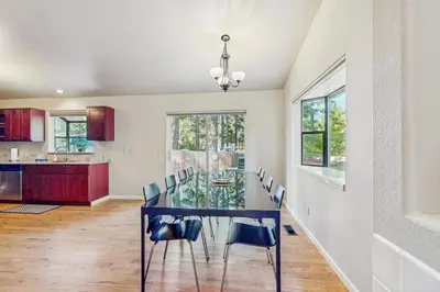 a dining room with a glass table and chairs at My Tahoe Sanctuary in South Lake Tahoe