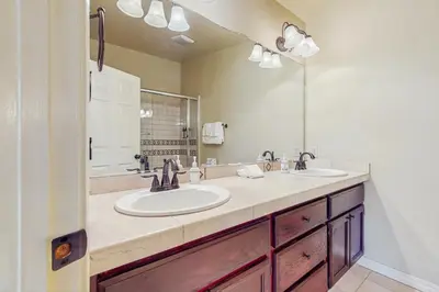 a bathroom with two sinks and a large mirror at My Tahoe Sanctuary in South Lake Tahoe