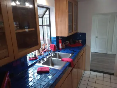 a kitchen with a sink and blue tiled counter top at Secluded Oasis with View, and hot tub on 50 acres in Bodfish