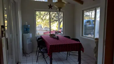 a dining room table with a red and white checkered table cloth at Secluded Oasis with View, and hot tub on 50 acres in Bodfish