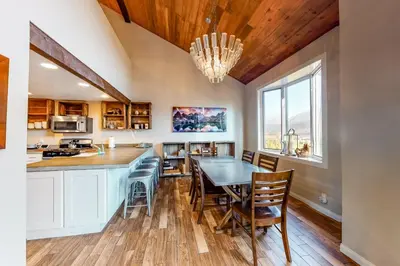 a kitchen and dining room with a table and chairs at Meadow Ridge 37 in Mammoth Lakes