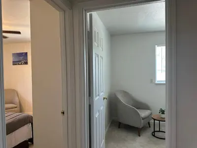 a room with a chair and a bed and a window at Suite E with 2-bedroom in Sacramento