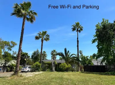 a house with palm trees in a yard at Suite E with 2-bedroom in Sacramento