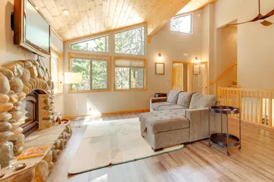 a living room with a couch and a fireplace at Near Ski Resorts and Trails Truckee Home with Hot Tub in Truckee