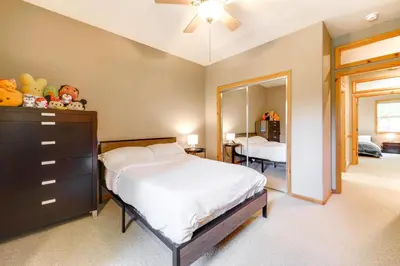 a bedroom with a bed and a dresser and a mirror at Near Ski Resorts and Trails Truckee Home with Hot Tub in Truckee