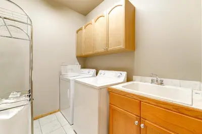a bathroom with a washer and dryer and a sink at Near Ski Resorts and Trails Truckee Home with Hot Tub in Truckee