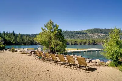 a row of chairs on a beach near a body of water at Near Ski Resorts and Trails Truckee Home with Hot Tub in Truckee