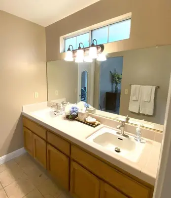 a bathroom with a sink and a large mirror at Modern Merced Haven near Merced College and UC Merced in Merced