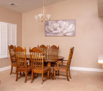 a dining room with a wooden table and chairs at Modern Merced Haven near Merced College and UC Merced in Merced
