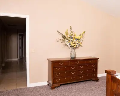 a vase of flowers sitting on top of a dresser at Modern Merced Haven near Merced College and UC Merced in Merced