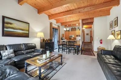 a living room with a leather couch and a table at Comfort in the Sierras - Edelweiss 2BR - Kirkwood condo in Markleeville