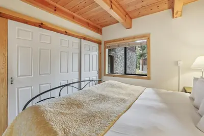a bedroom with a white bed and a window at Comfort in the Sierras - Edelweiss 2BR - Kirkwood condo in Markleeville