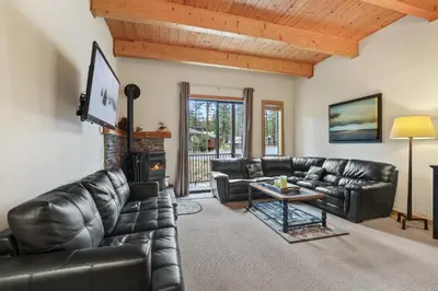 a living room with leather furniture and a fireplace at Comfort in the Sierras - Edelweiss 2BR - Kirkwood condo in Markleeville