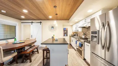 a kitchen with a wooden ceiling and a dining table at Near Ski Beach Hiking Trails Clubhouse Pool Hot Tub Access Juanita Blue by AvantStay in Incline Village