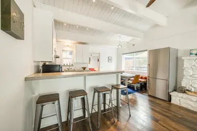 a kitchen with bar stools and a counter top at Bluejay Hideaway by Tahoe Getaways - Kings Beach 3 BR Pet Friendly w Enclosed Yard and Hot Tub in Kings Beach