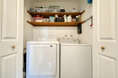 a small laundry room with a washer and dryer at Bluejay Hideaway by Tahoe Getaways - Kings Beach 3 BR Pet Friendly w Enclosed Yard and Hot Tub in Kings Beach