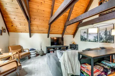 a living room with a couch and a table at Sleek Blue Lake Springs Retreat with Deck and Yard! in Arnold