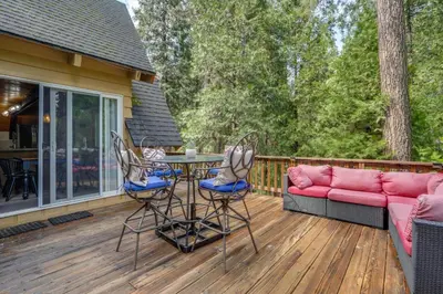 a deck with a couch and a table and chairs at Sleek Blue Lake Springs Retreat with Deck and Yard! in Arnold