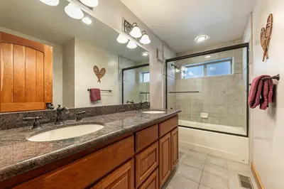 a bathroom with two sinks and a large mirror at Twin Hollow at Dollar Point by Tahoe Getaways - 5BR w Game Room & Hot Tub in Tahoe City