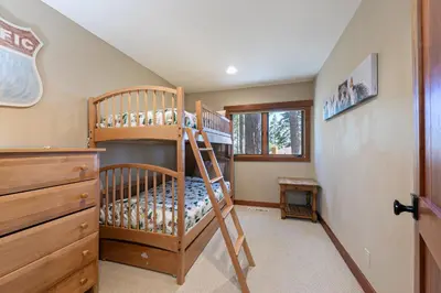 a bedroom with two bunk beds and a staircase at Twin Hollow at Dollar Point by Tahoe Getaways - 5BR w Game Room & Hot Tub in Tahoe City