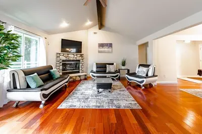 a living room with two couches and a fireplace at Yosemite and Bass lake I Hot tub I Game room I Sleeps 13 in Oakhurst