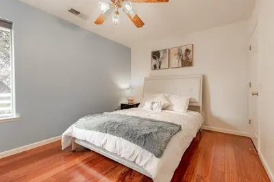 a bedroom with a bed and a ceiling fan at Yosemite and Bass lake I Hot tub I Game room I Sleeps 13 in Oakhurst
