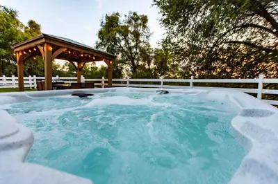 a hot tub with a gazebo in a backyard at Yosemite and Bass lake I Hot tub I Game room I Sleeps 13 in Oakhurst