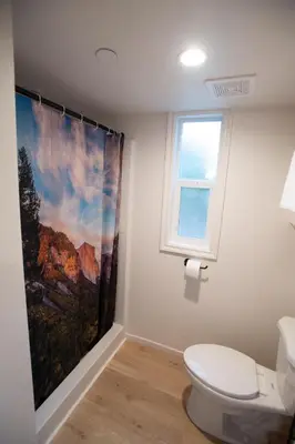 a bathroom with a toilet and a painting on the wall at Tiny Blanca at Yosemite Gateway in Groveland