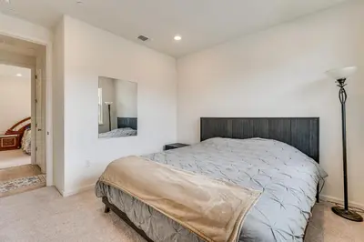 a bedroom with a large bed and a mirror at Newly Built Home with Patio 4 Mi to Dtwn Hollister in Hollister