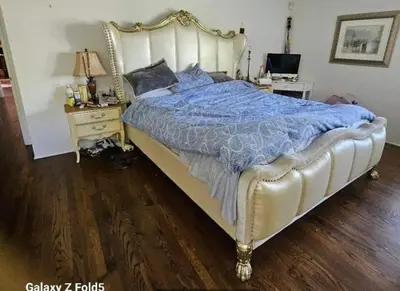 a bedroom with a large bed and a desk at Peaceful family home in Fresno