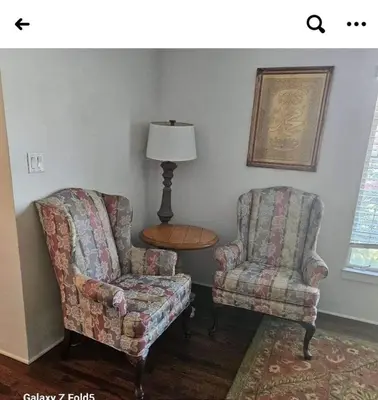 two chairs and a table and a lamp in a room at Peaceful family home in Fresno