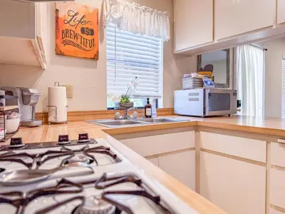 a kitchen with a stove top oven next to a sink at Studio Loft Near Yosemite with Kitchenette in Oakhurst