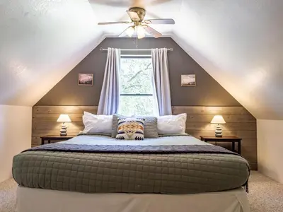 a bedroom with a large bed in a attic at Studio Loft Near Yosemite with Kitchenette in Oakhurst