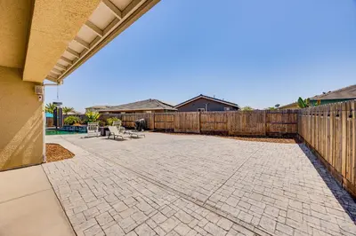 a patio with a fence and a wooden at 1 Mi to Golf! Spacious and Modern Home in Dinuba in Dinuba
